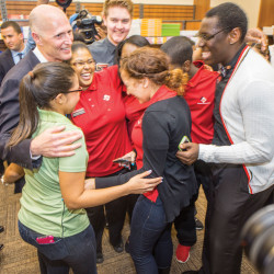 Students share a group hug with Gov. Rick Scott during a visit to Osceola Campus to share his proposal for tax-free textbooks.